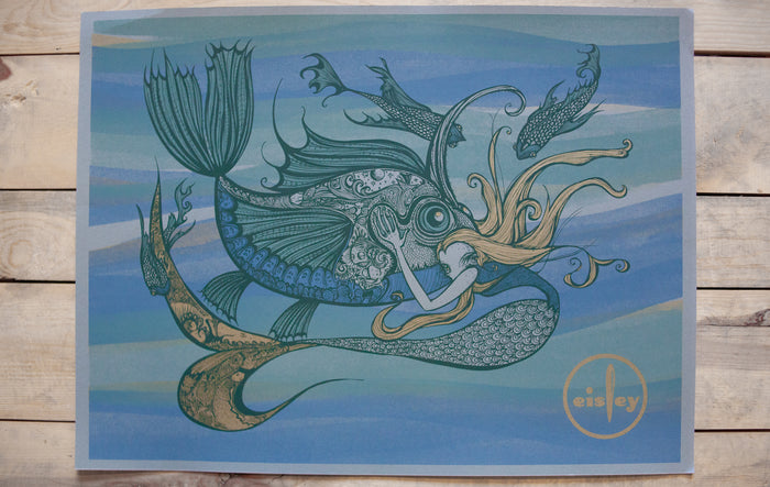 A detailed, artistic fantasy fish with ornate patterns and a human face, inspired by Currents artwork, set on a blue-green wavy background. Eisley (brand name) appears in yellow inside an oval at the bottom right.