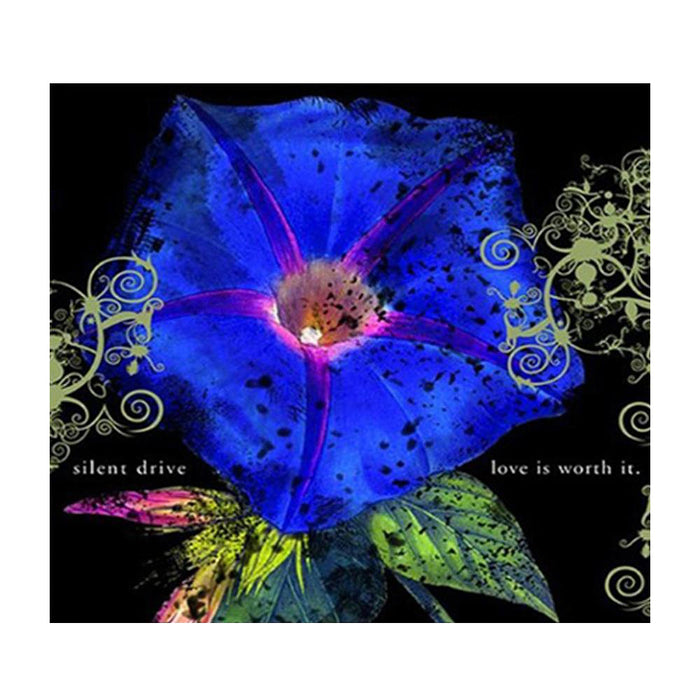 A vibrant blue flower with dark spots and pink veins is framed by swirling yellow-green patterns on a black background. “Silent Drive” appears on the left and “love is worth it.” on the right, both in lowercase, exuding a punk rock vibe. Brand: Silent Drive.