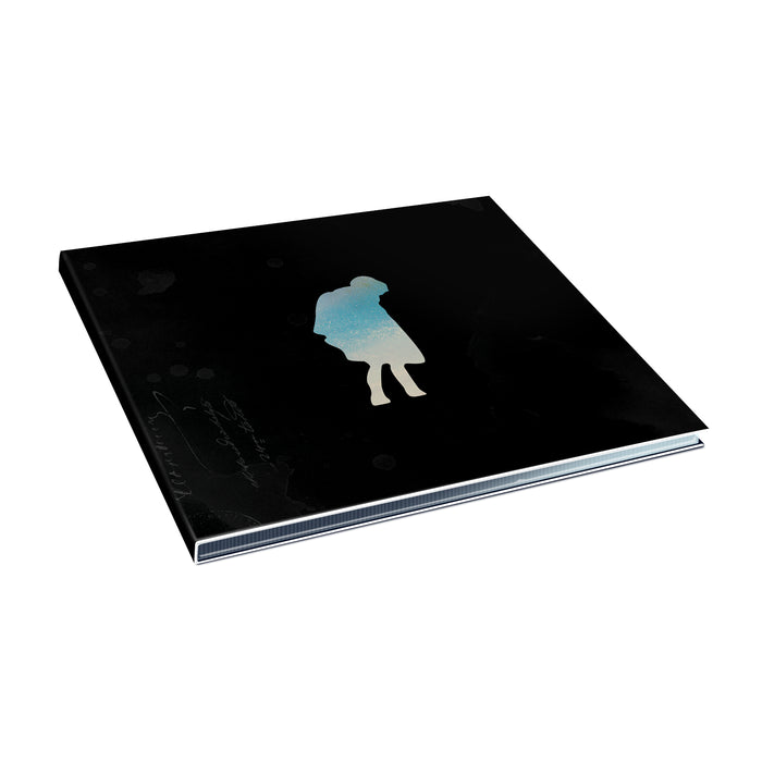 A black hardcover Special Edition book by I The Mighty lies closed on a white surface, its cover displaying a silhouetted figure against a gradient blue-and-white background.