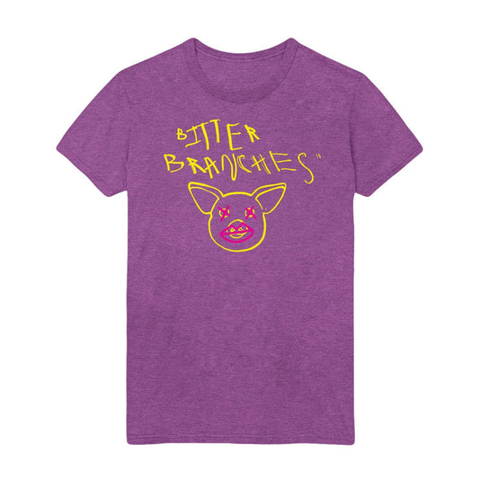 Purple tshirt with scratchy style yellow text reading Bitter Branches on the top part of the shirt with a yellow outline of a pig face below. Pink Xs are drawn over the pig's eyes and pink lips are drawn over the pig's snout.