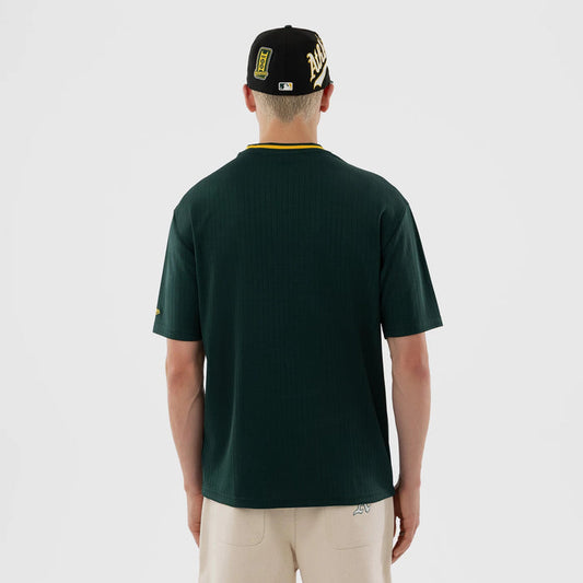 The model is wearing this MLB Athletics Oversized T-Shirt in dark green. 2