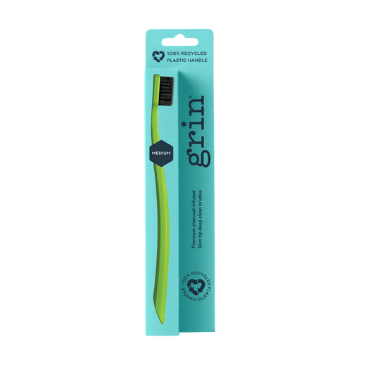 Grin 100% Recycled Toothbrush Medium Lime on teal packaging with dark charcoal bristles, white background. Text reads "Medium" and "100% Recycled Plastic Handle".