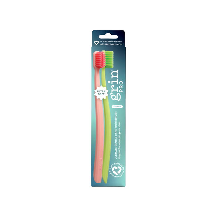 Grin Pro Ultimate Gentle Care Toothbrush Ultra Soft duo pack in pink and green on white background, teal packaging labelled "Ultra Soft"