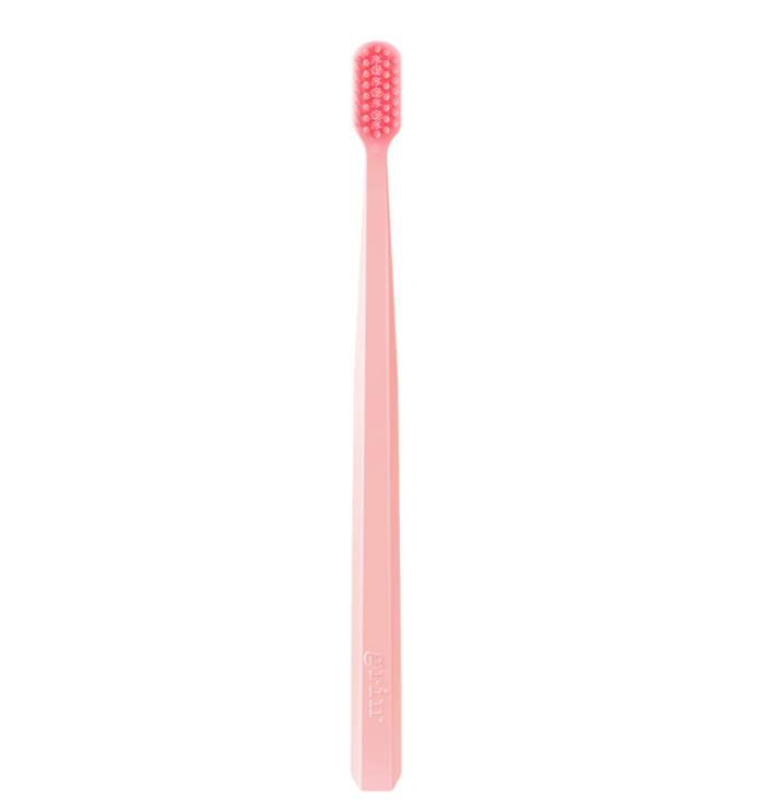 Grin Pro Ultimate Gentle Care Ultra Soft pink toothbrush with pink bristles, Grin logo on handle, white background.