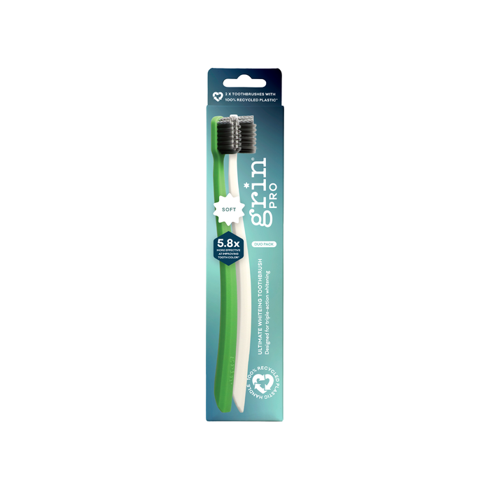 Grin Pro Ultimate Whitening Toothbrush Soft 2 Pack in green and white with charcoal bristles in teal packaging on white background.