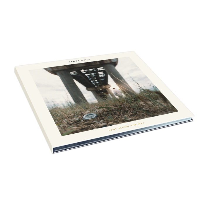 Sleep On It’s vinyl record album Lost Along the Way features the EP cover with ground under a bridge, blurred grass, and beams. Includes tracks like Counting Miles. Check out the full track list.