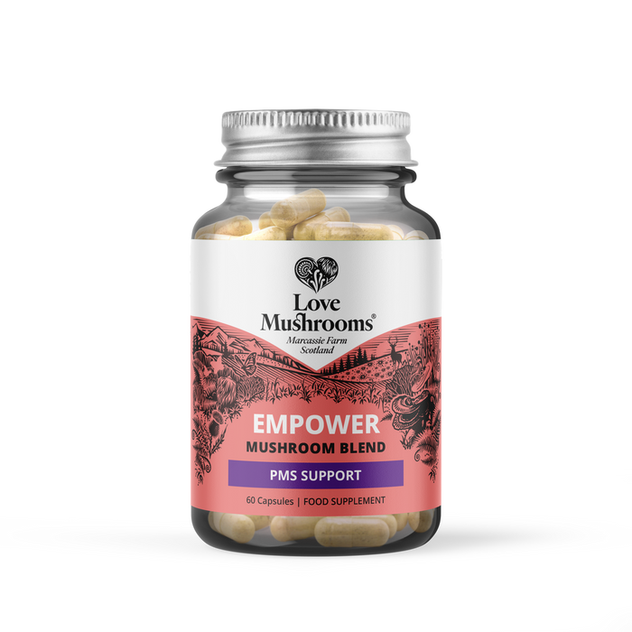 Love Mushrooms Empower PMS GO 60 Capsules in a clear glass jar with silver lid on white background, label reads "PMS Support Mushroom Blend"