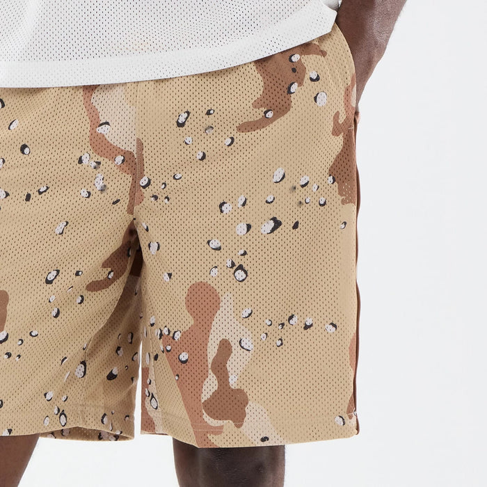 The model is wearing this New Era Bermuda Oversized Shorts in Woodland Camo. 4