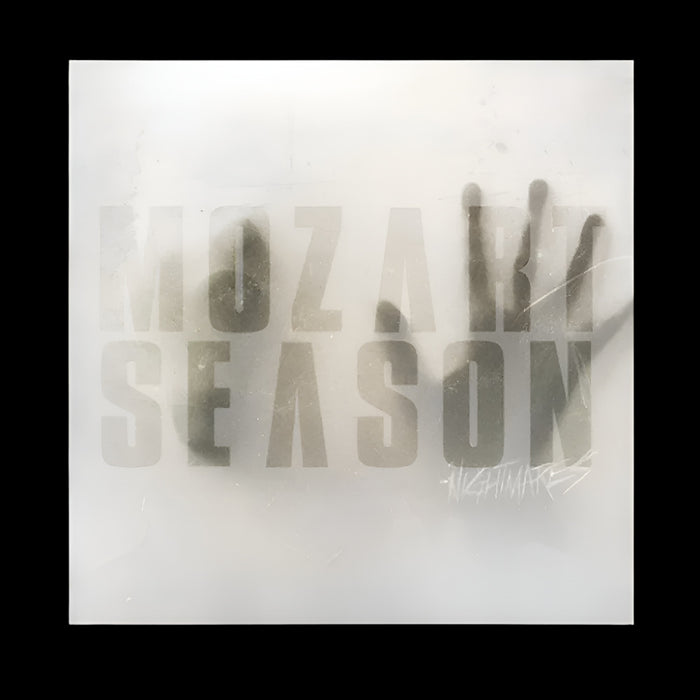A foggy glass surface with two dark handprints behind it. Bold letters spell Mozart Season, with Nightmares handwritten in the bottom right corner—like a chilling album cover from the brand Mozart Season.