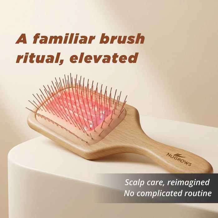 NuGROWS VivaBrush Pro wooden paddle brush with red laser light and metal pins on beige background