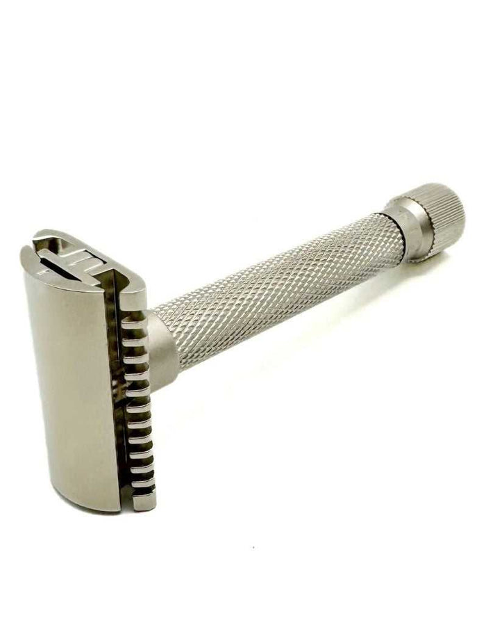 Close-up of satin chrome safety razor with textured grip and adjustable head