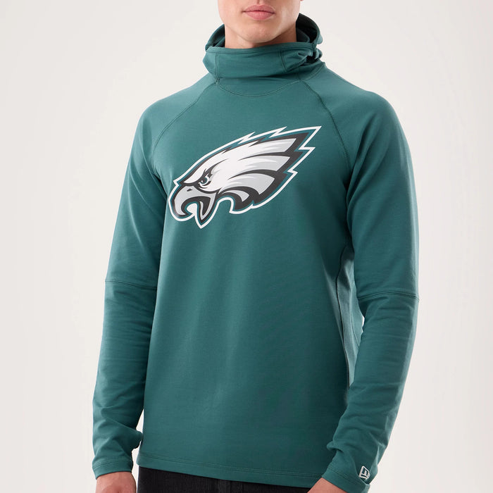 The model is wearing this NFL Sideline 2026 Philadelphia Eagles Balaclava Hoodie in dark green. 4