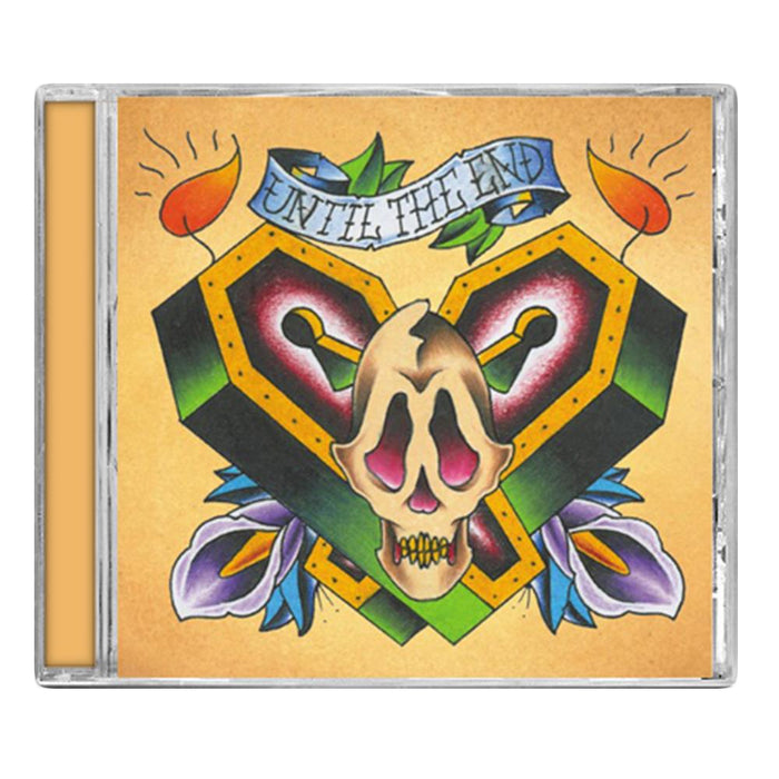 The debut EP’s CD cover from Until The End shows a tattoo-style heart-shaped coffin with a skull, purple flowers, and candles. A blue banner on a golden-yellow background reads “UNTIL THE END,” reflecting the brand’s message-driven roots.