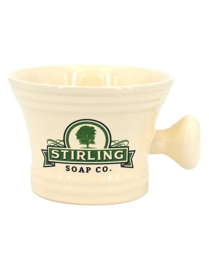 Cream-colored ceramic shaving mug with ridged base and Stirling Soap Co. logo featuring a tree, designed for grooming and soap lathering