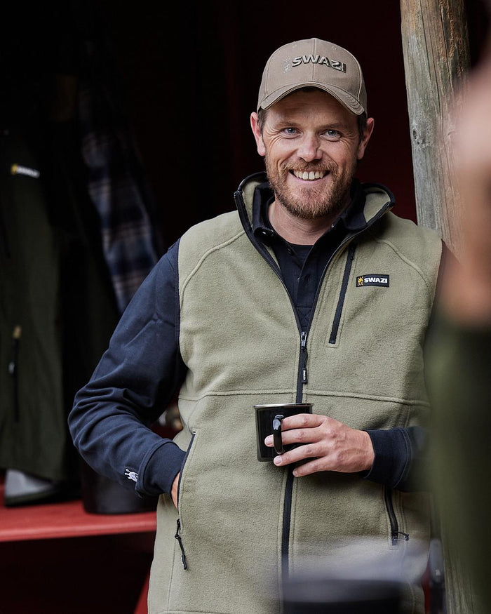 Tussock Coloured Swazi Sherpa Vest on blurry background #colour_tussock