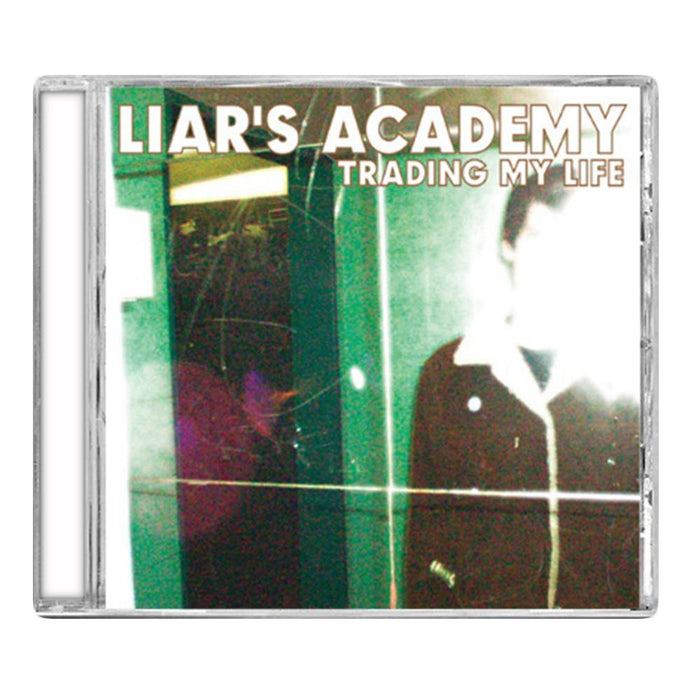 CD cover for "Trading My Life" by Liars Academy, showcasing a blurred, overexposed indoor photo of a person with bold white and gold text at the top—captures the true rock and roll vibe of Liars Academy.