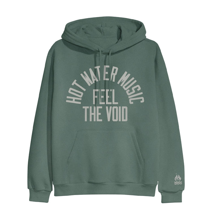 Alpine green colored pullover hoodie with HOT WATER MUSIC written across the chest in a half circle.  Below that there is text that says FEEL THE VOID. On the bottom of one sleeve, there is a drawing of a fire with two lines underneath it representing water.