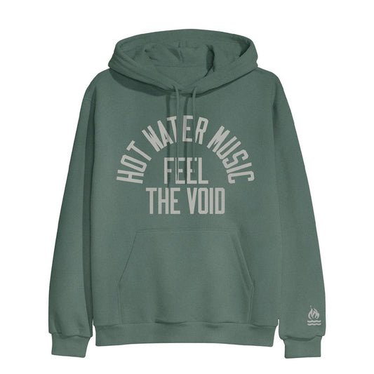 Alpine green colored pullover hoodie with HOT WATER MUSIC written across the chest in a half circle.  Below that there is text that says FEEL THE VOID. On the bottom of one sleeve, there is a drawing of a fire with two lines underneath it representing water.