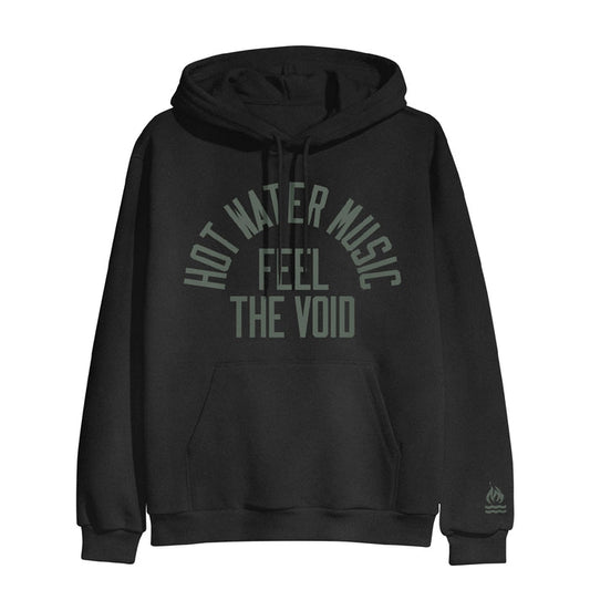 Black pullover hoodie with HOT WATER MUSIC written across the chest in a semi circle. Below that there is text that says FEEL THE VOID. On the bottom of one sleeve, there is a drawing of a fire with two lines underneath it representing water.